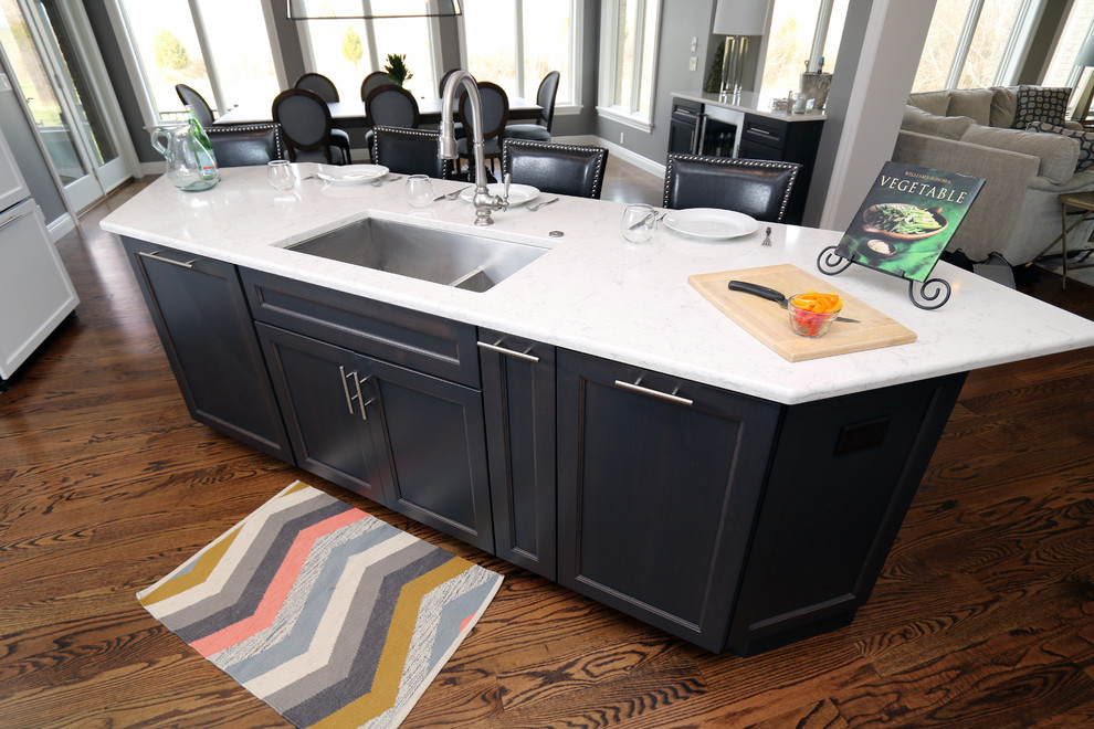 Large transitional u-shaped dark wood floor open concept kitchen photo in Cincinnati with a single-bowl sink, flat-panel cabinets, white cabinets, granite countertops, gray backsplash, subway tile backsplash, paneled appliances and an island