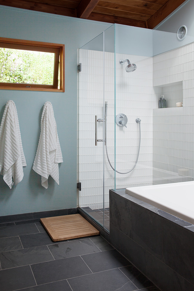 Midcentury master bathroom in San Francisco with a drop-in tub, a corner shower, white tile, glass tile, blue walls and slate floors.