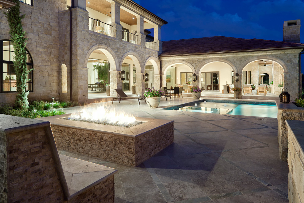 Inspiration for a mediterranean patio in Austin with a fire feature and no cover.