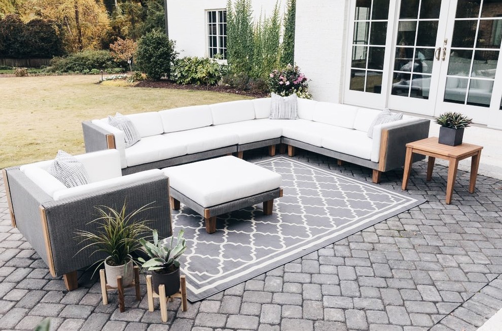 This is an example of a mid-sized contemporary backyard patio in New York with concrete pavers and no cover.