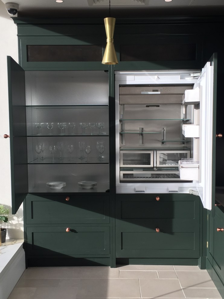 Inspiration for a mid-sized traditional l-shaped separate kitchen in Belfast with shaker cabinets, green cabinets, quartzite benchtops, white splashback, stone slab splashback, white appliances, limestone floors, no island, beige floor and white benchtop.