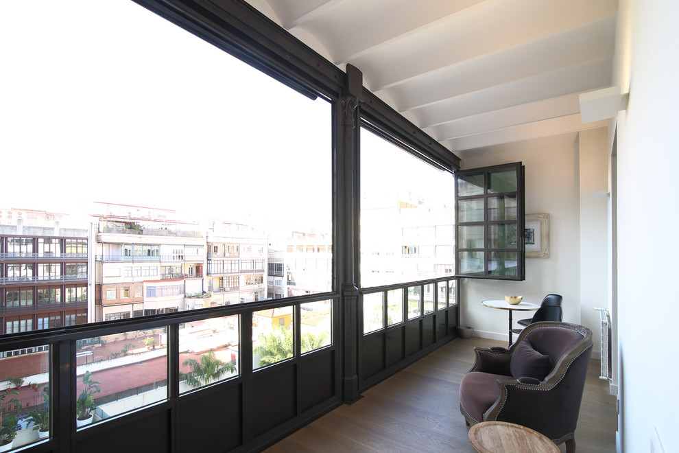 Photo of a mid-sized transitional sunroom in Barcelona with light hardwood floors, no fireplace and a standard ceiling.