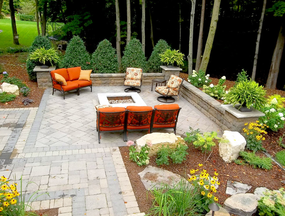 Inspiration for a traditional patio in Minneapolis with brick pavers and a fire feature.