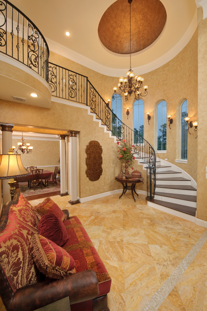 Traditional foyer in Houston with beige walls and orange floor.