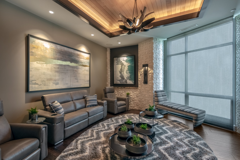 Design ideas for a large contemporary open concept home theatre in Omaha with grey walls, porcelain floors, a wall-mounted tv and brown floor.