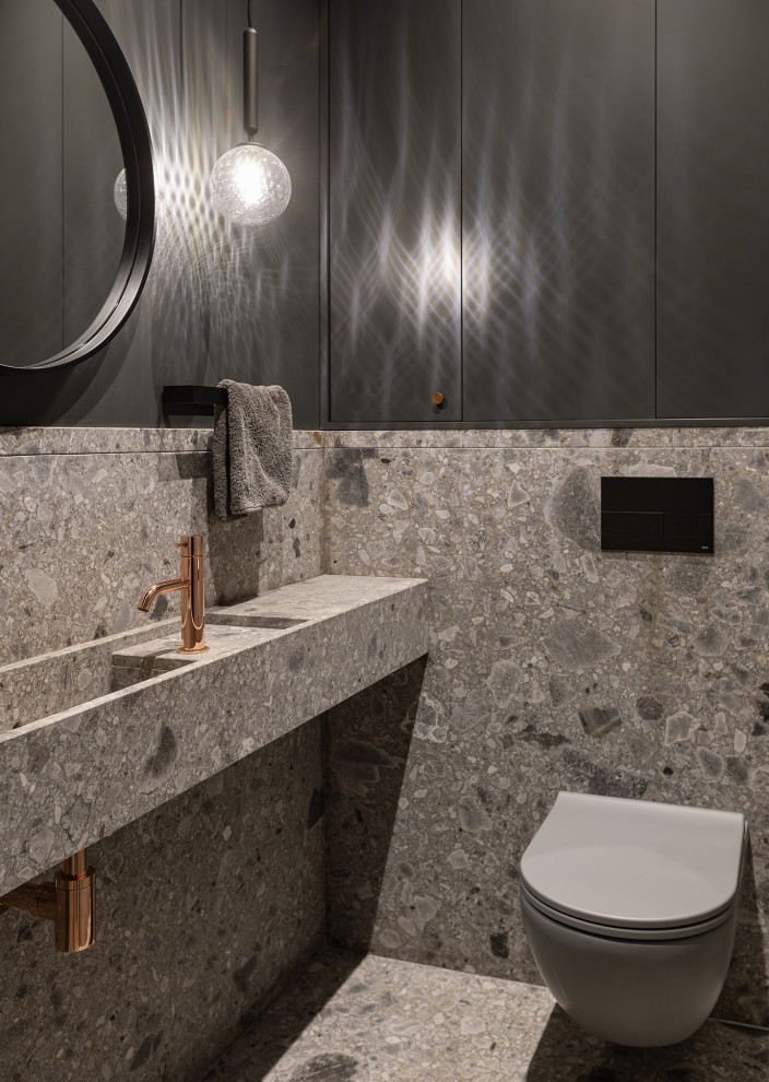 Esempio di un piccolo bagno di servizio contemporaneo con WC sospeso, piastrelle grigie, piastrelle di marmo, pareti grigie, pavimento in marmo, lavabo sospeso, top in marmo, pavimento grigio, top grigio e pannellatura