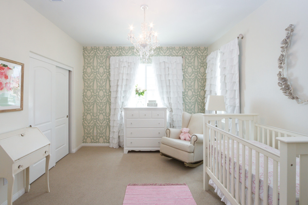This is an example of a traditional nursery for girls in Orange County with carpet and beige floor.