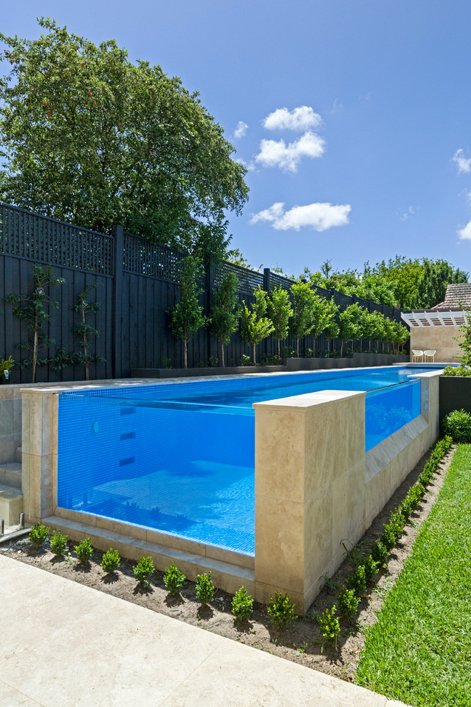 Photo of a large modern backyard custom-shaped aboveground pool in Melbourne with tile.