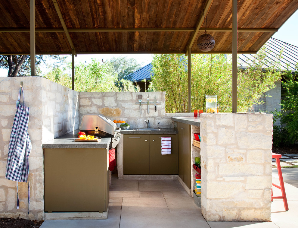 Design ideas for a contemporary backyard patio in Austin with an outdoor kitchen.