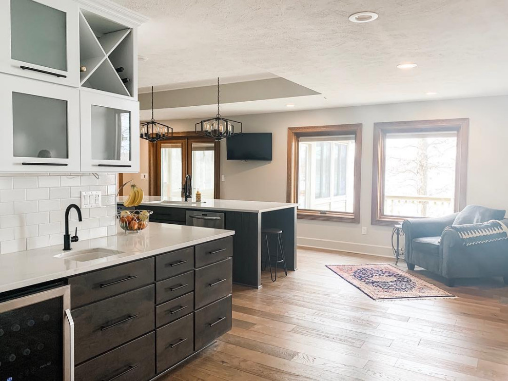 Kitchen - transitional light wood floor kitchen idea in Indianapolis with an undermount sink, quartz countertops, white backsplash, subway tile backsplash, stainless steel appliances, an island and white countertops