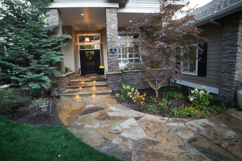 This is an example of a large arts and crafts entryway in Portland with a double front door and a black front door.