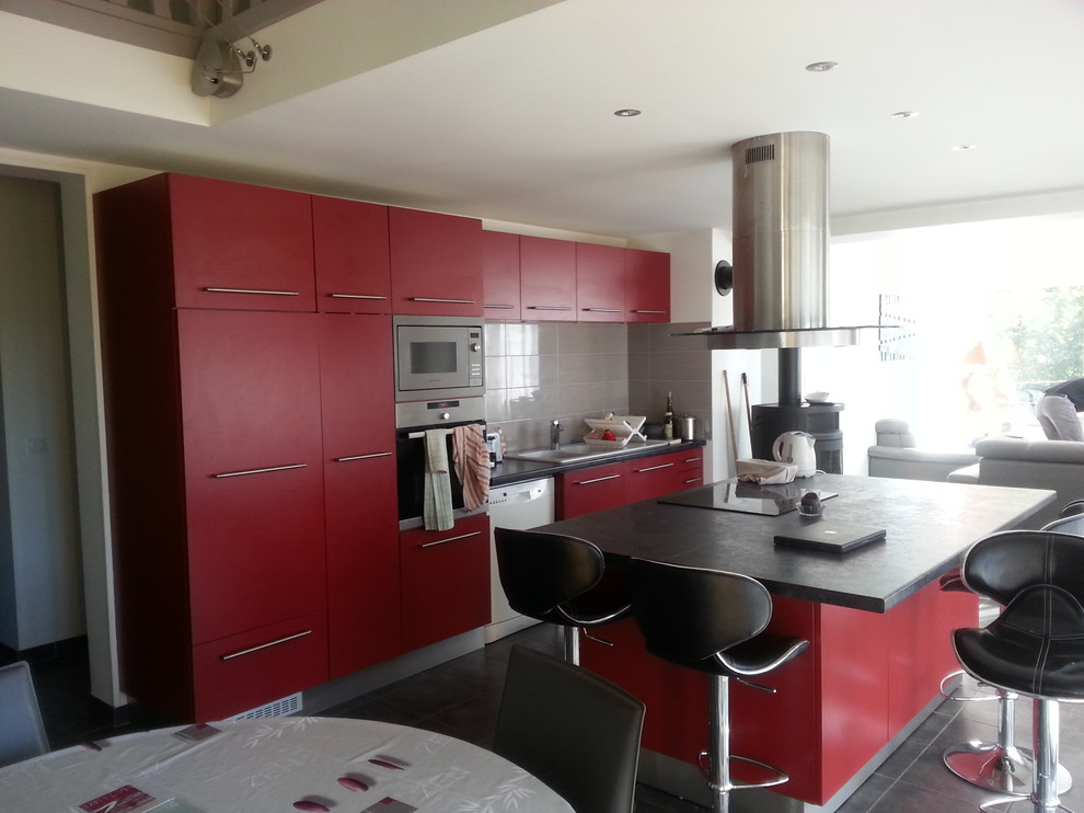 Inspiration for a mid-sized contemporary single-wall open plan kitchen in Dijon with an undermount sink, beaded inset cabinets, red cabinets, laminate benchtops, grey splashback, ceramic splashback, stainless steel appliances, ceramic floors and with island.