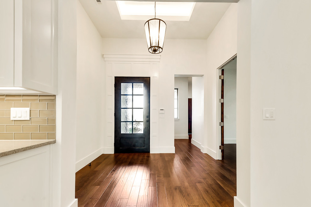 Inspiration for a mid-sized transitional front door in Dallas with beige walls, medium hardwood floors, a single front door and a metal front door.