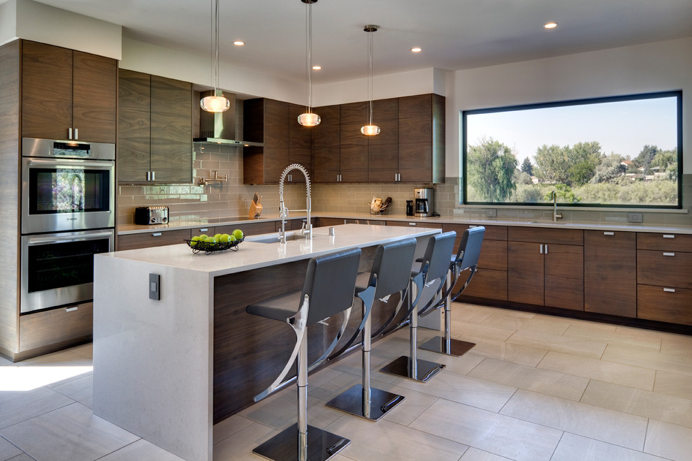 Design ideas for a mid-sized contemporary l-shaped kitchen in Seattle with an undermount sink, flat-panel cabinets, dark wood cabinets, quartz benchtops, beige splashback, glass tile splashback, stainless steel appliances, ceramic floors, with island and grey floor.