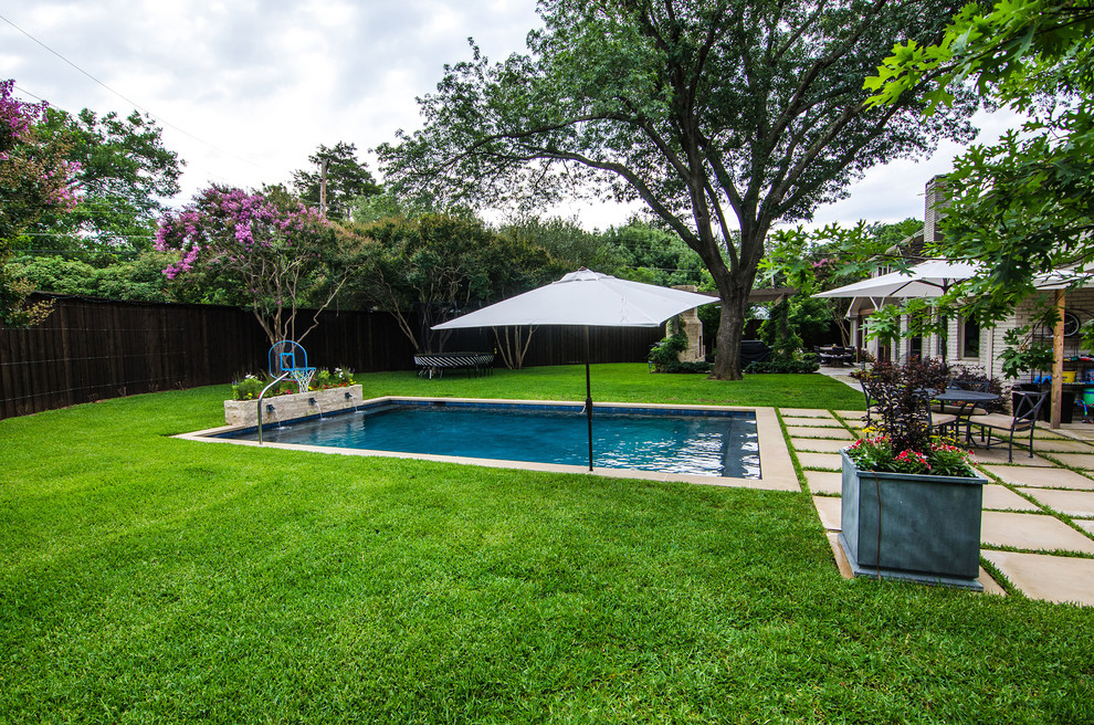 Mid-sized transitional backyard rectangular pool fountain photo in Dallas with decking