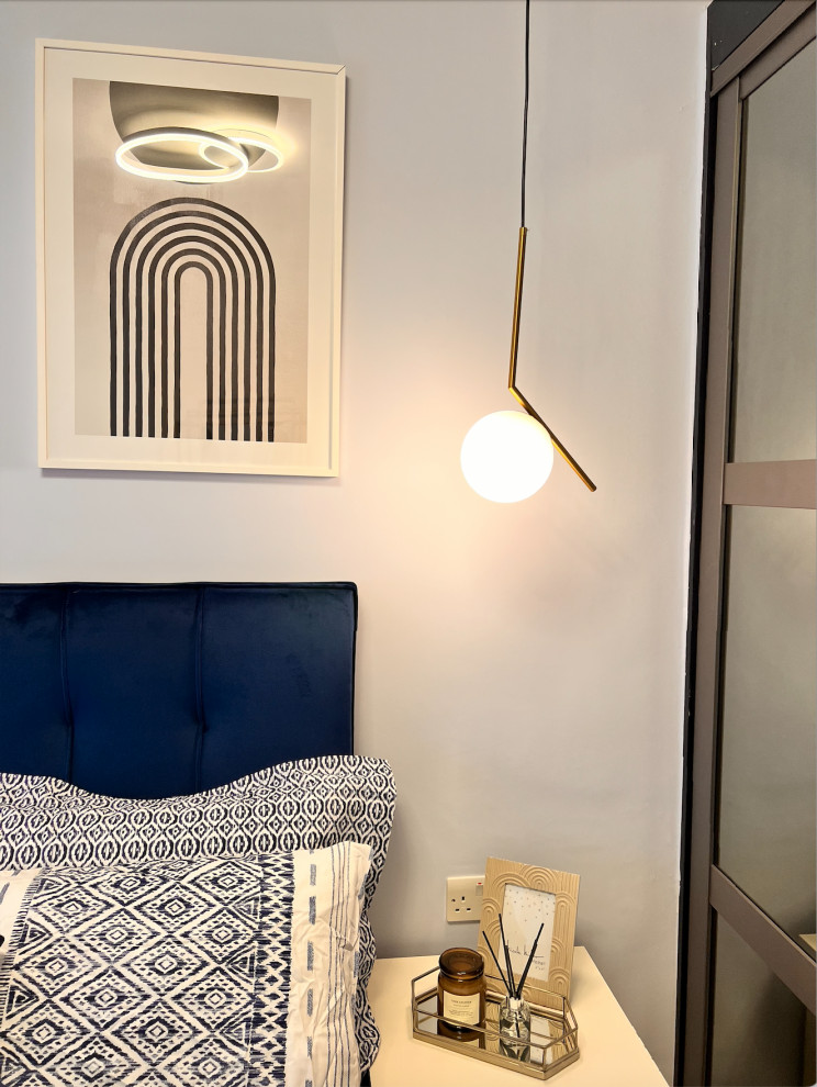 Inspiration for a small contemporary master bedroom in London with blue walls, medium hardwood flooring, brown floors and feature lighting.