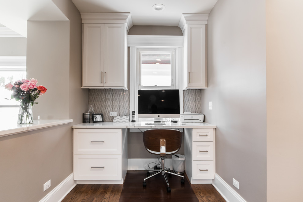 Mid-sized transitional l-shaped medium tone wood floor and brown floor eat-in kitchen photo in Chicago with an undermount sink, recessed-panel cabinets, white cabinets, quartzite countertops, gray backsplash, subway tile backsplash, black appliances, no island and multicolored countertops