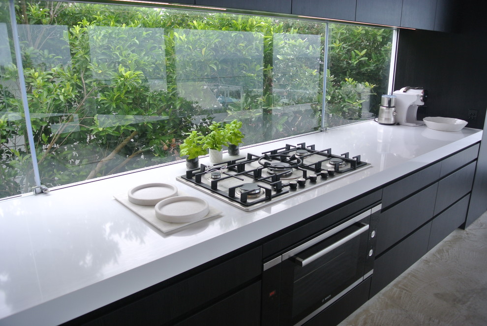 Inspiration for a large contemporary single-wall open plan kitchen in Sunshine Coast with a double-bowl sink, flat-panel cabinets, dark wood cabinets, quartz benchtops, window splashback, stainless steel appliances, concrete floors, with island and grey floor.
