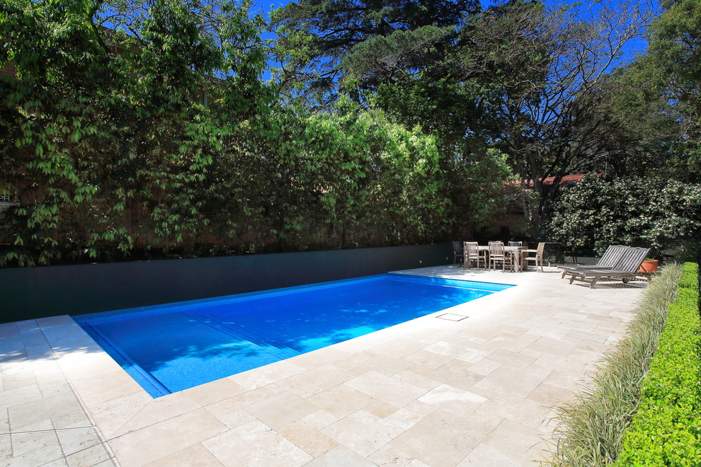 Design ideas for a mid-sized contemporary backyard rectangular pool in Sydney with natural stone pavers.