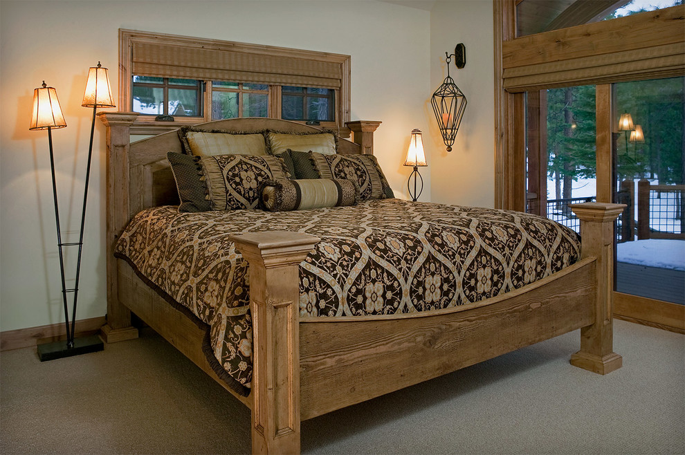 Example of a large mountain style guest carpeted bedroom design with beige walls and no fireplace