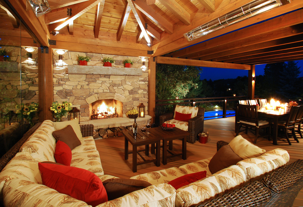 Inspiration for a large country backyard deck in Denver with a pergola and a fire feature.