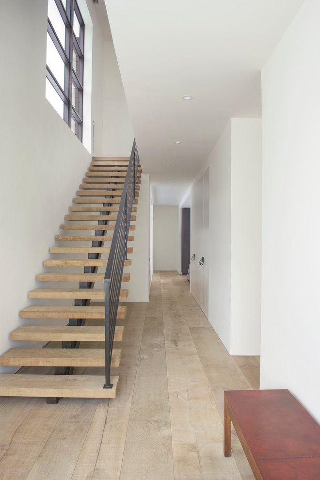 Inspiration for a mid-sized country wood straight staircase in Denver with open risers.