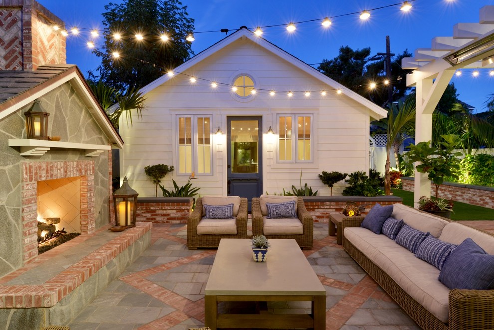 Design ideas for a small beach style backyard patio in San Diego with a fire feature, tile and no cover.