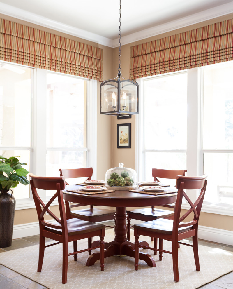 This is an example of a traditional dining room in Sacramento with beige walls and dark hardwood floors.
