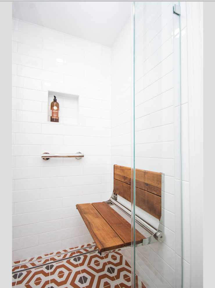 This is an example of a small eclectic master bathroom in Providence with recessed-panel cabinets, dark wood cabinets, a curbless shower, a two-piece toilet, white tile, subway tile, beige walls, mosaic tile floors, a drop-in sink, orange floor and a hinged shower door.