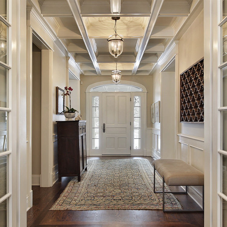 Photo of a large transitional foyer in Toronto with black walls, dark hardwood floors, a single front door and a white front door.
