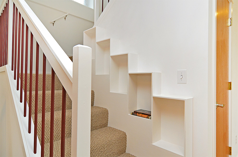 This is an example of a mid-sized arts and crafts carpeted u-shaped staircase in Seattle with wood risers.