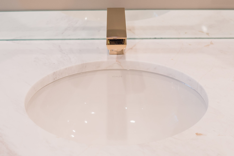 Example of a mid-sized transitional master blue tile and porcelain tile marble floor and white floor alcove shower design with flat-panel cabinets, beige walls, an undermount sink and marble countertops