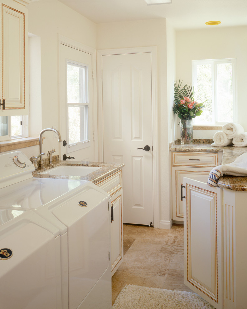 Design ideas for a traditional l-shaped dedicated laundry room in San Diego with an undermount sink, raised-panel cabinets, beige cabinets, white walls, a side-by-side washer and dryer, beige floor, granite benchtops, porcelain floors and brown benchtop.