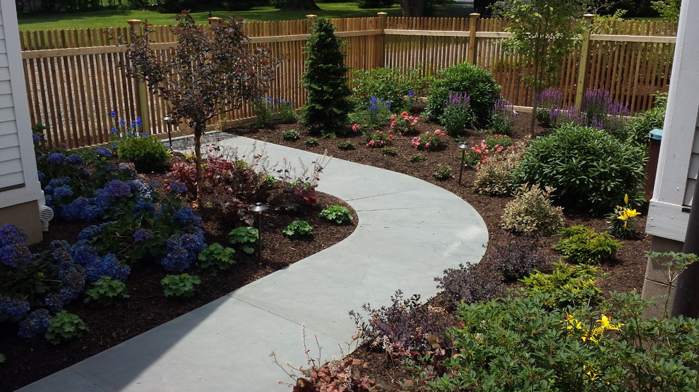 This is an example of a large traditional side yard gravel garden path in Other for summer.