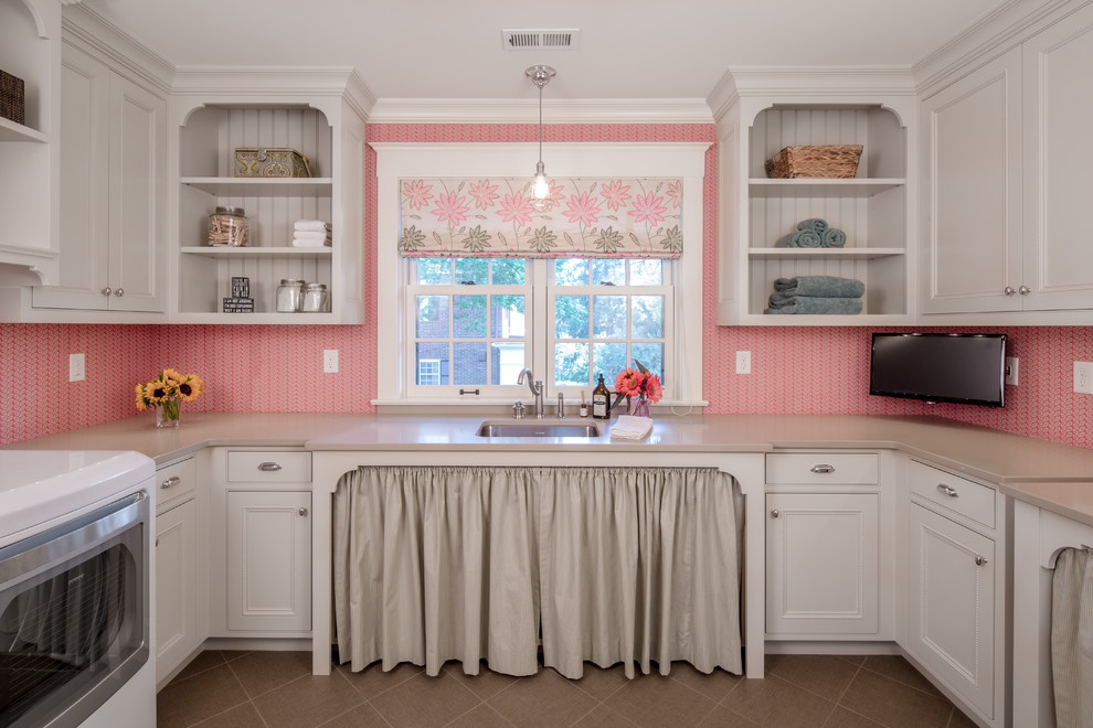 Design ideas for a large traditional u-shaped utility room in Minneapolis with an undermount sink, beaded inset cabinets, white cabinets, solid surface benchtops, pink walls, ceramic floors and a side-by-side washer and dryer.