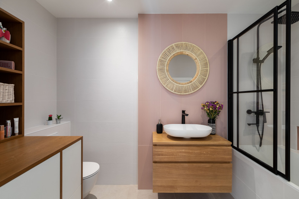 Photo of a medium sized contemporary grey and pink ensuite bathroom in Paris with beaded cabinets, brown cabinets, a submerged bath, a built-in shower, grey tiles, ceramic tiles, pink walls, ceramic flooring, a vessel sink, wooden worktops, grey floors, an open shower, brown worktops and a floating vanity unit.