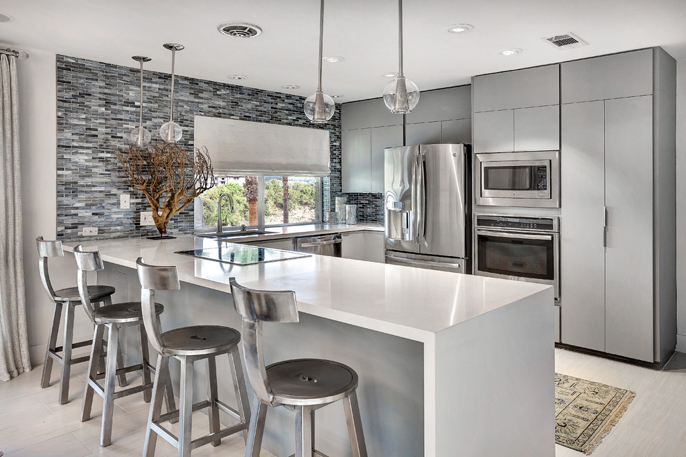 Design ideas for a mid-sized contemporary u-shaped eat-in kitchen in Austin with an undermount sink, flat-panel cabinets, grey cabinets, grey splashback, matchstick tile splashback, stainless steel appliances, a peninsula, quartz benchtops and ceramic floors.