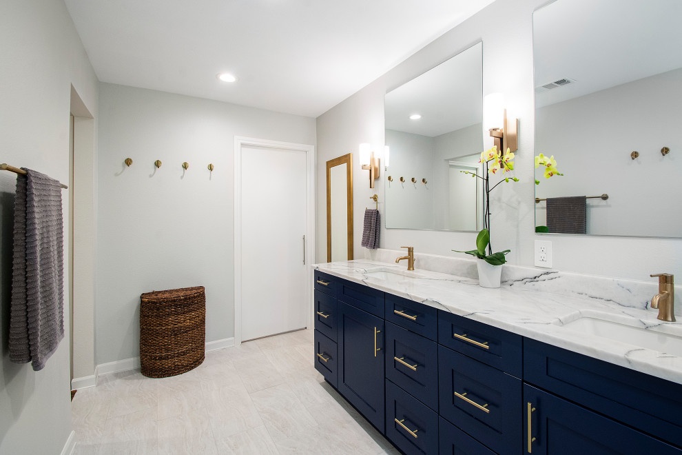 Inspiration for a large contemporary master bathroom in Dallas with flat-panel cabinets, blue cabinets, a double shower, gray tile, cement tile, an undermount sink, marble benchtops, a hinged shower door, white benchtops, a two-piece toilet, grey walls, porcelain floors and beige floor.