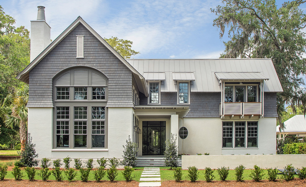 Transitional two-storey beige house exterior in Atlanta with mixed siding, a gable roof and a metal roof.