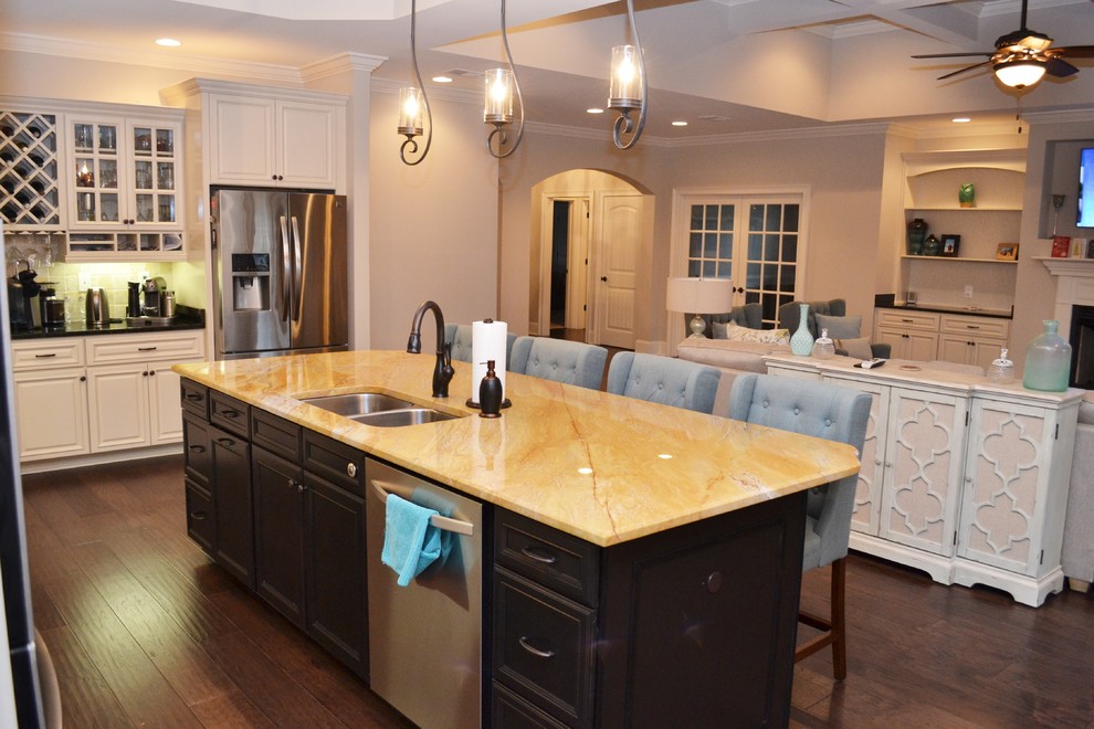 Inspiration for a mid-sized transitional galley medium tone wood floor and brown floor eat-in kitchen remodel with an undermount sink, shaker cabinets, white cabinets, granite countertops, beige backsplash, ceramic backsplash, stainless steel appliances and an island