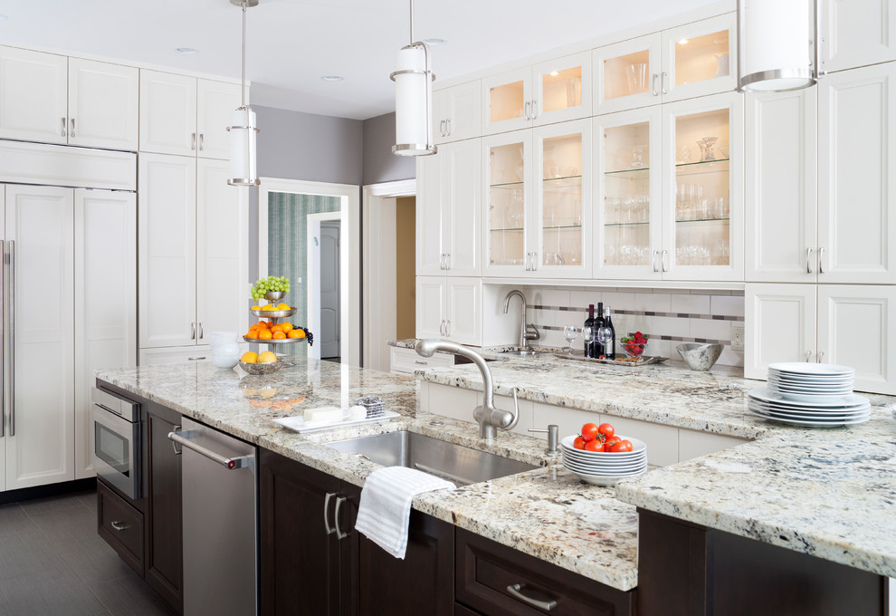 Inspiration for a large transitional u-shaped ceramic tile enclosed kitchen remodel in Baltimore with a single-bowl sink, recessed-panel cabinets, white cabinets, granite countertops, white backsplash, subway tile backsplash, stainless steel appliances and an island