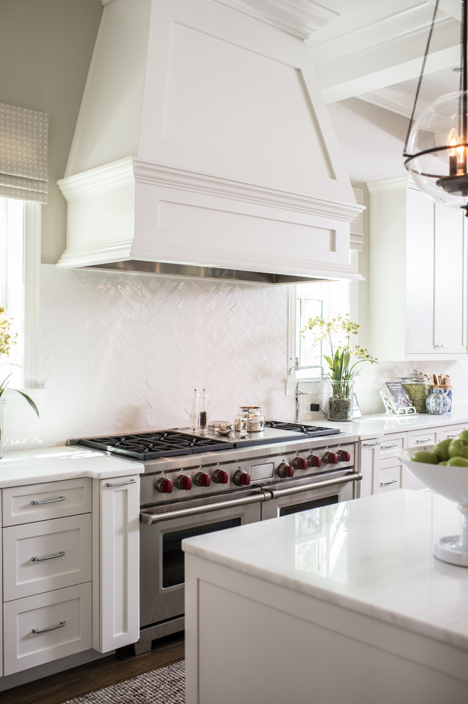 Inspiration for a large transitional u-shaped kitchen in Orlando with shaker cabinets, white cabinets, white splashback, subway tile splashback, with island and white benchtop.