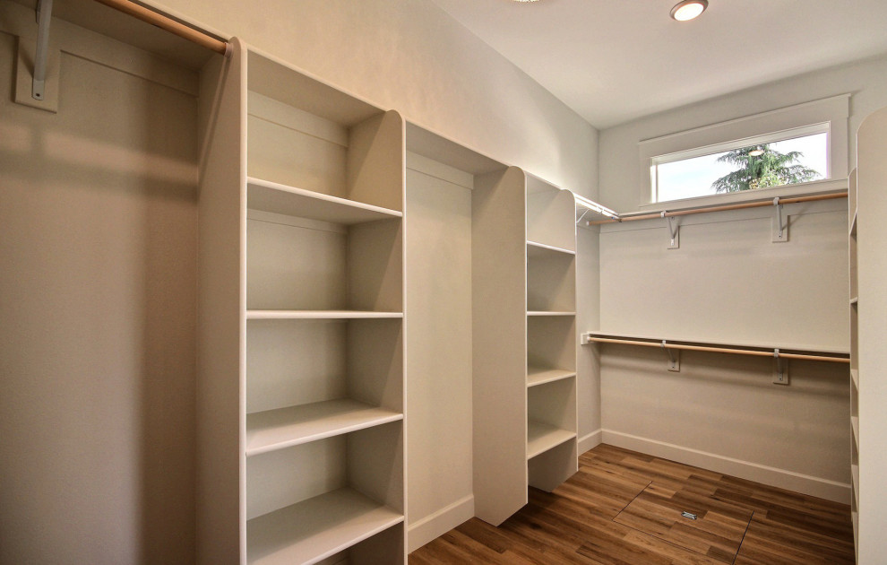 Walk-in closet - huge modern gender-neutral light wood floor and brown floor walk-in closet idea in Portland with open cabinets and white cabinets