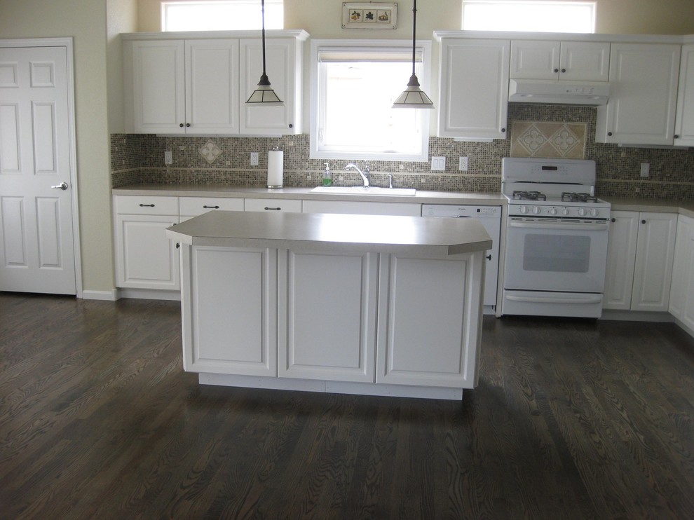Open concept kitchen - large transitional l-shaped dark wood floor open concept kitchen idea with a double-bowl sink, raised-panel cabinets, white cabinets, laminate countertops, multicolored backsplash, ceramic backsplash, white appliances and an island