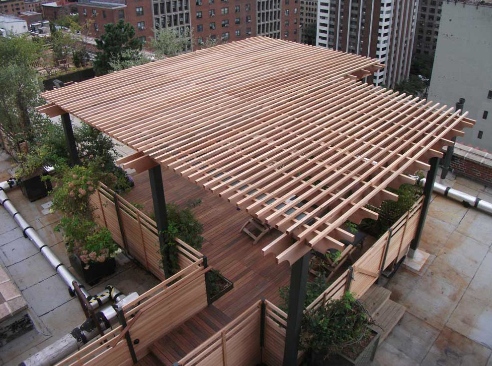 Design ideas for a large contemporary rooftop deck in New York with a pergola.