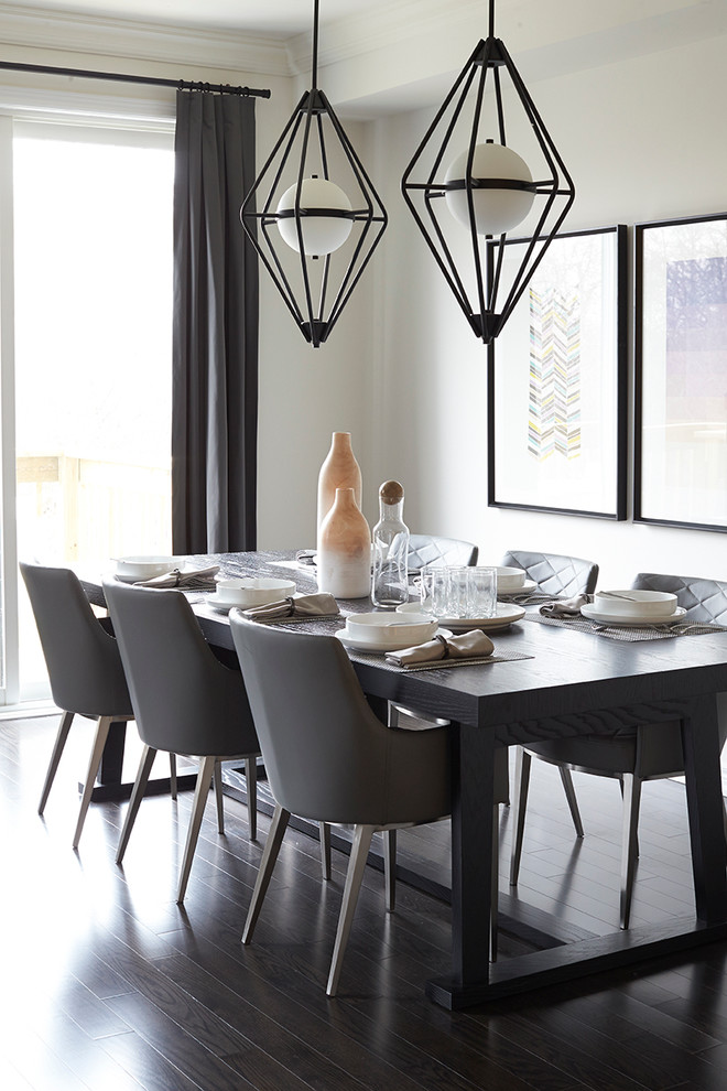 Contemporary dining room in Toronto with white walls and dark hardwood floors.