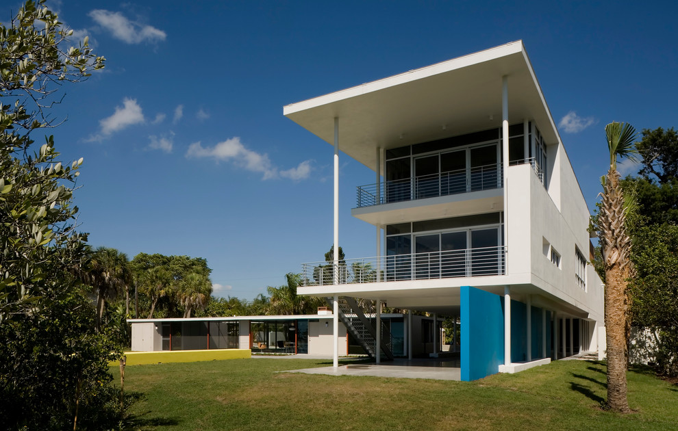 Photo of a midcentury three-storey exterior in Tampa with a flat roof.
