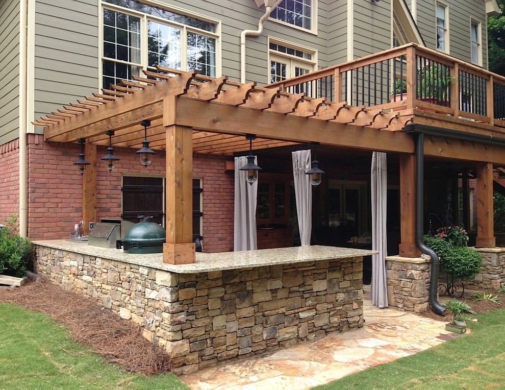 Photo of a mid-sized traditional backyard deck in Atlanta with an outdoor kitchen and a pergola.