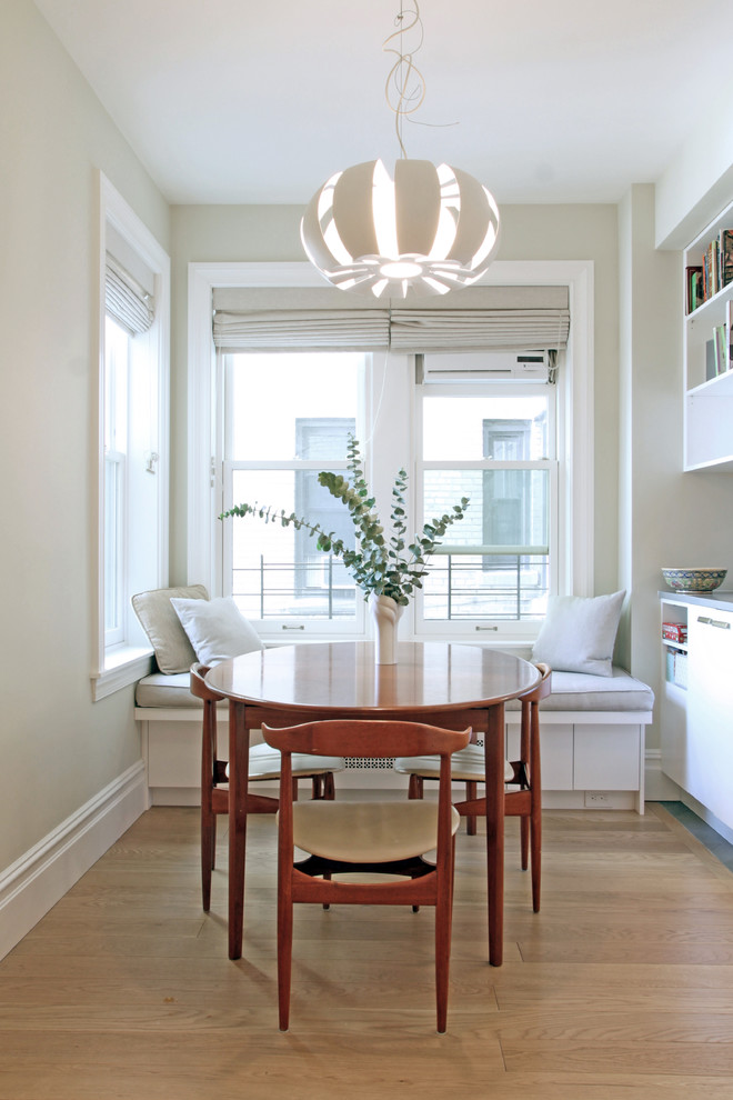 Inspiration for a small transitional dining room in New York with white walls, light hardwood floors and beige floor.