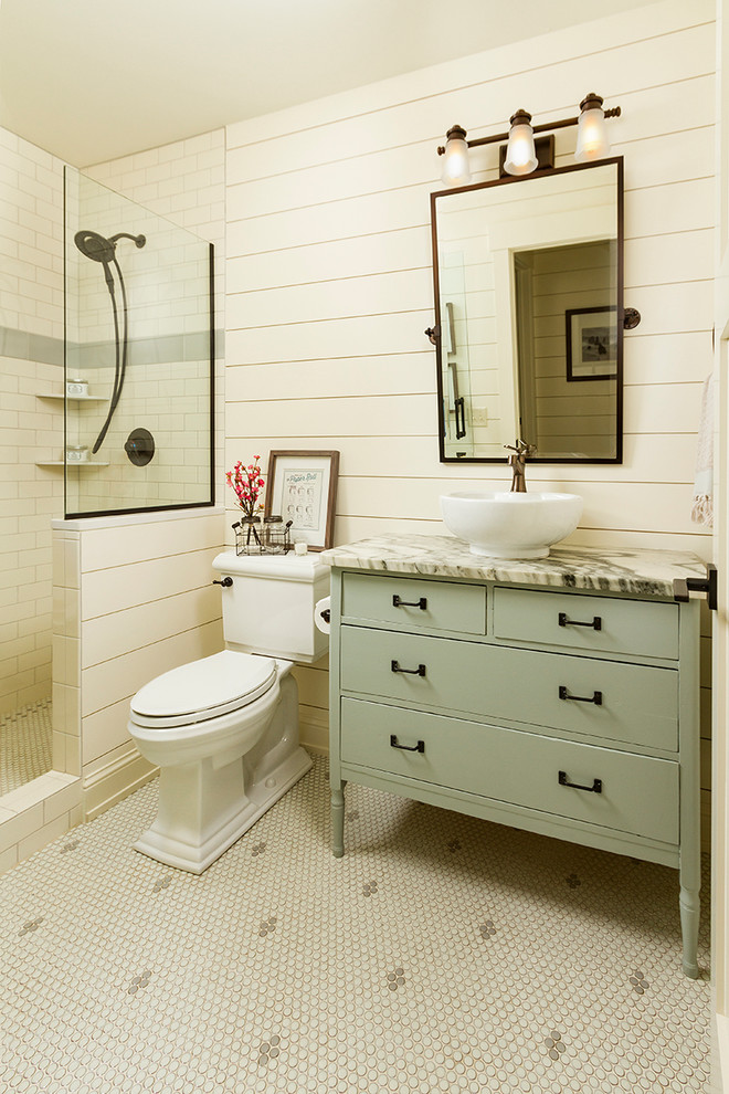 Inspiration for a mid-sized country 3/4 bathroom in Minneapolis with an open shower, a two-piece toilet, white tile, subway tile, mosaic tile floors, a vessel sink, marble benchtops, flat-panel cabinets, green cabinets, beige walls and an open shower.